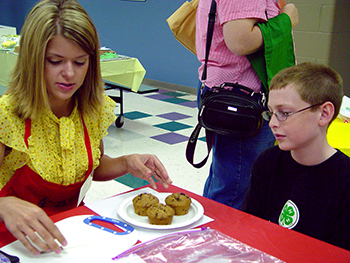 Food judge at county fair judging youth's baked goods