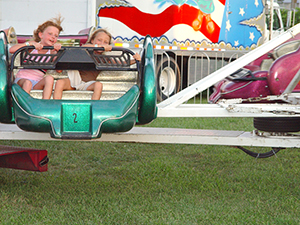 Two girls ride carnival ride